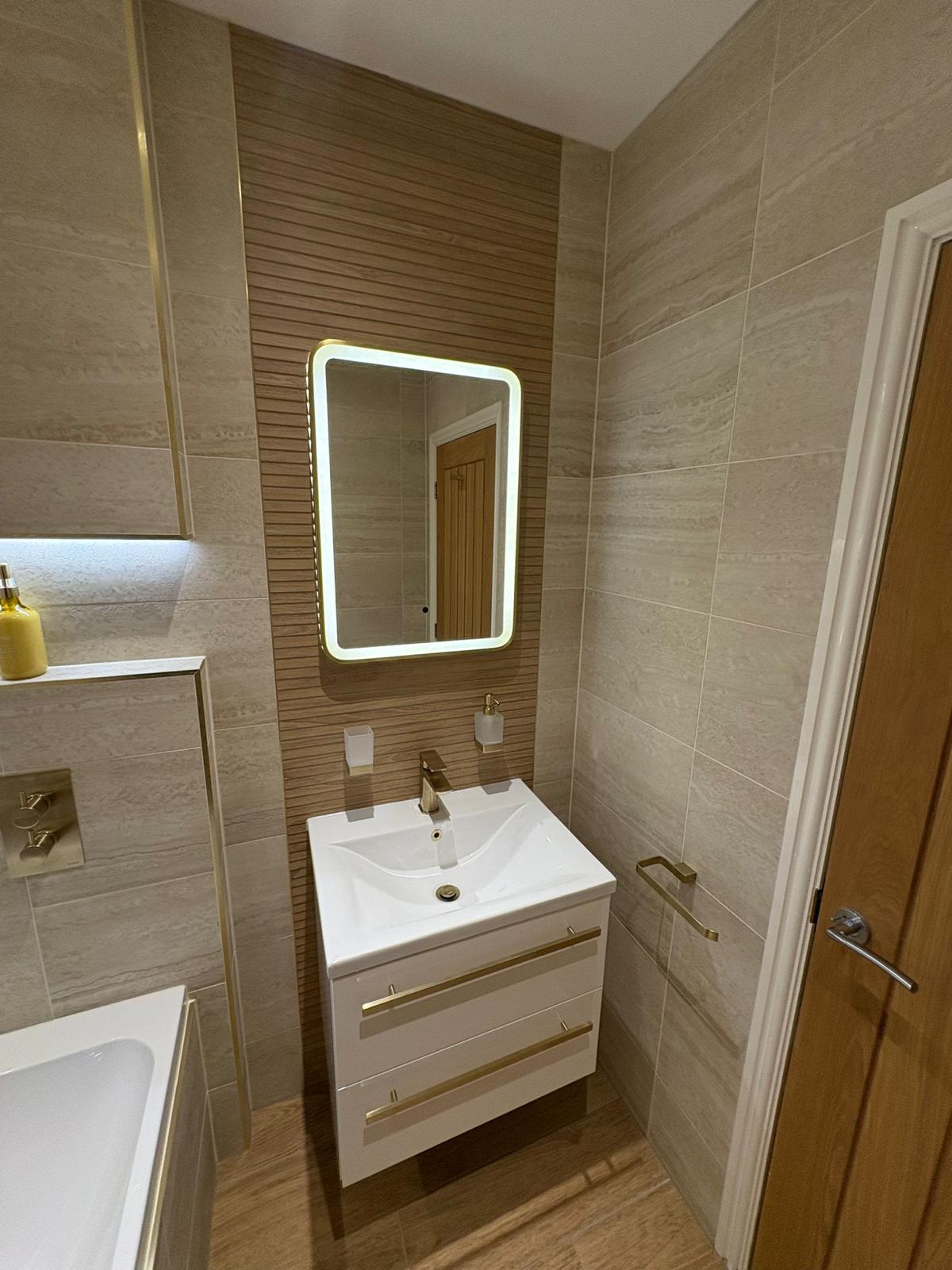 LED mirror with white wall-mounted vanity unit