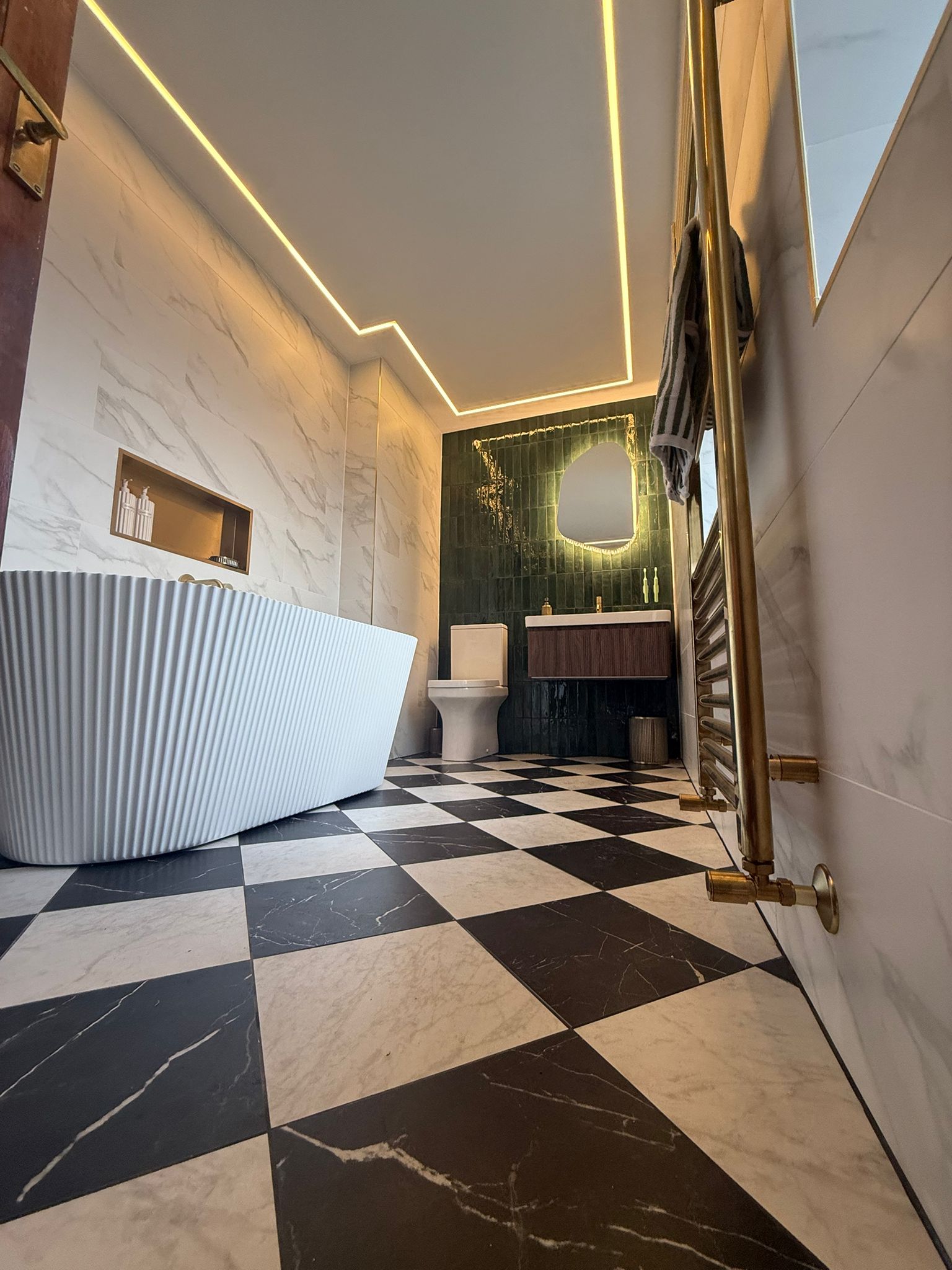 Luxury bathroom with chequerboard floor full view