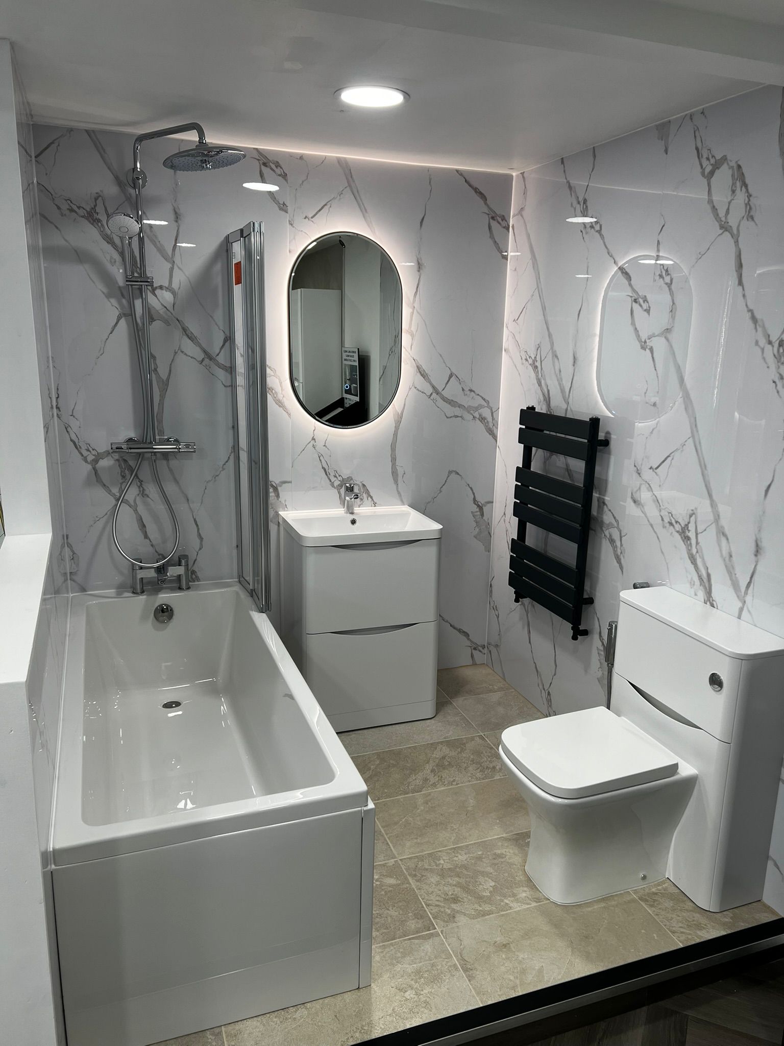 Marble bathroom with oval mirror