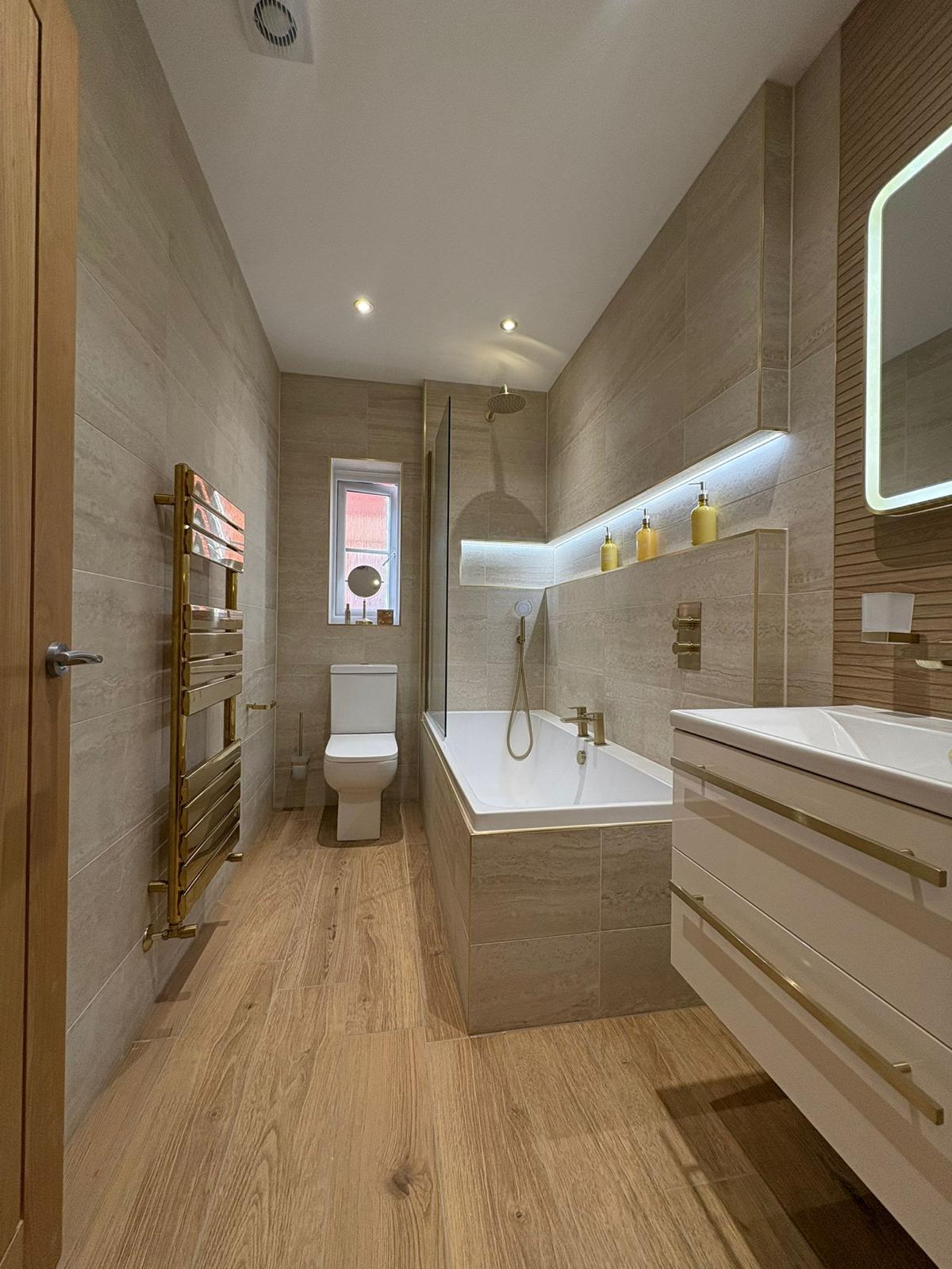 Modern bathroom suite with LED niche lighting