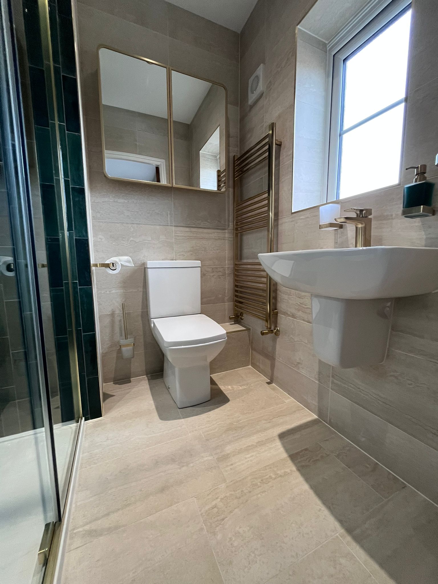 Modern bathroom with gold heated towel rail